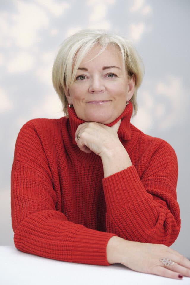 Jo Malone in red jumper