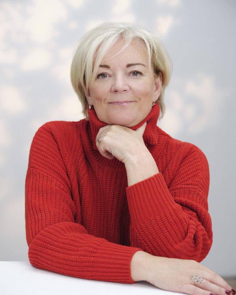 Jo Malone in red jumper