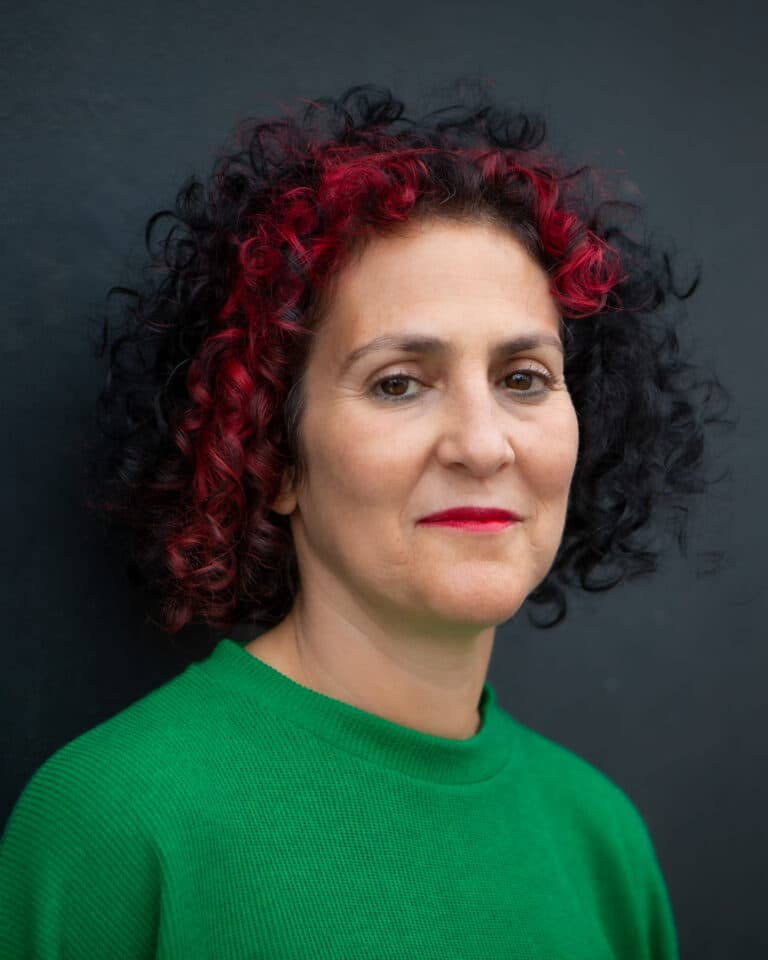 Benita Matofska, sustainability speaker looking at camera