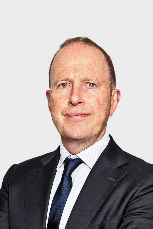 Dominic O'Donnell looking at camera