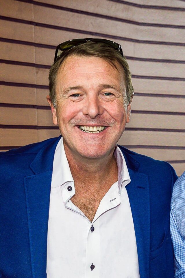 Phil Tufnell after-dinner speaker smiling in a blue suit