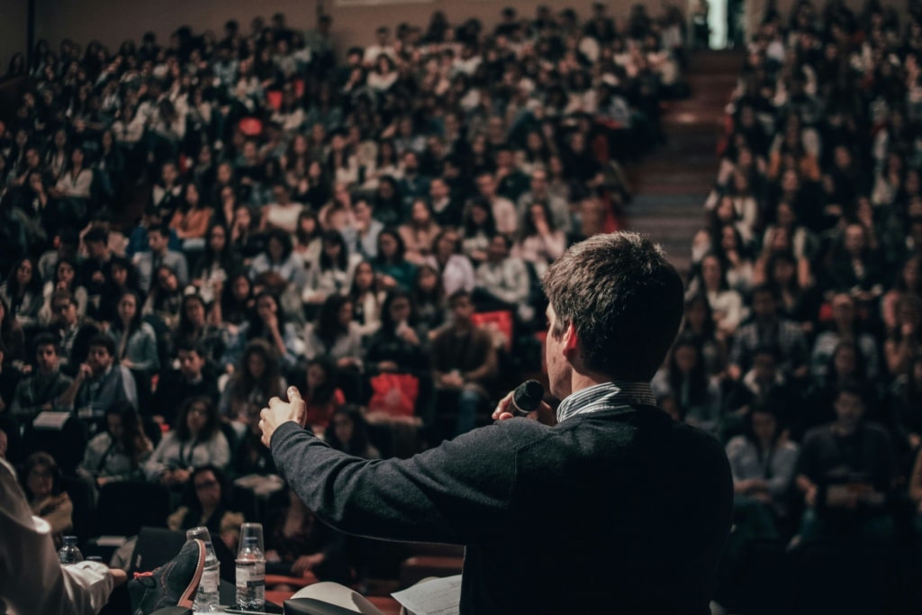 man delivering a speech to an audience